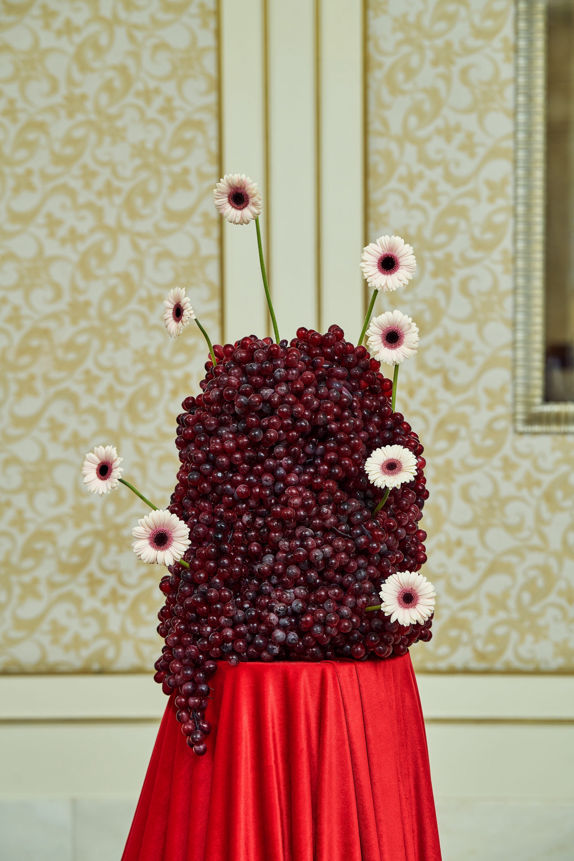 Red drapery, grapes, citrus and floral installations at a Dubai gala event, by Flower Corner — photo 75