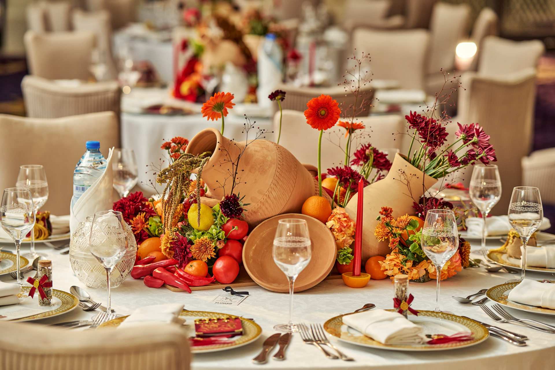 Red drapery, grapes, citrus and floral installations at a Dubai gala event, by Flower Corner — photo 164
