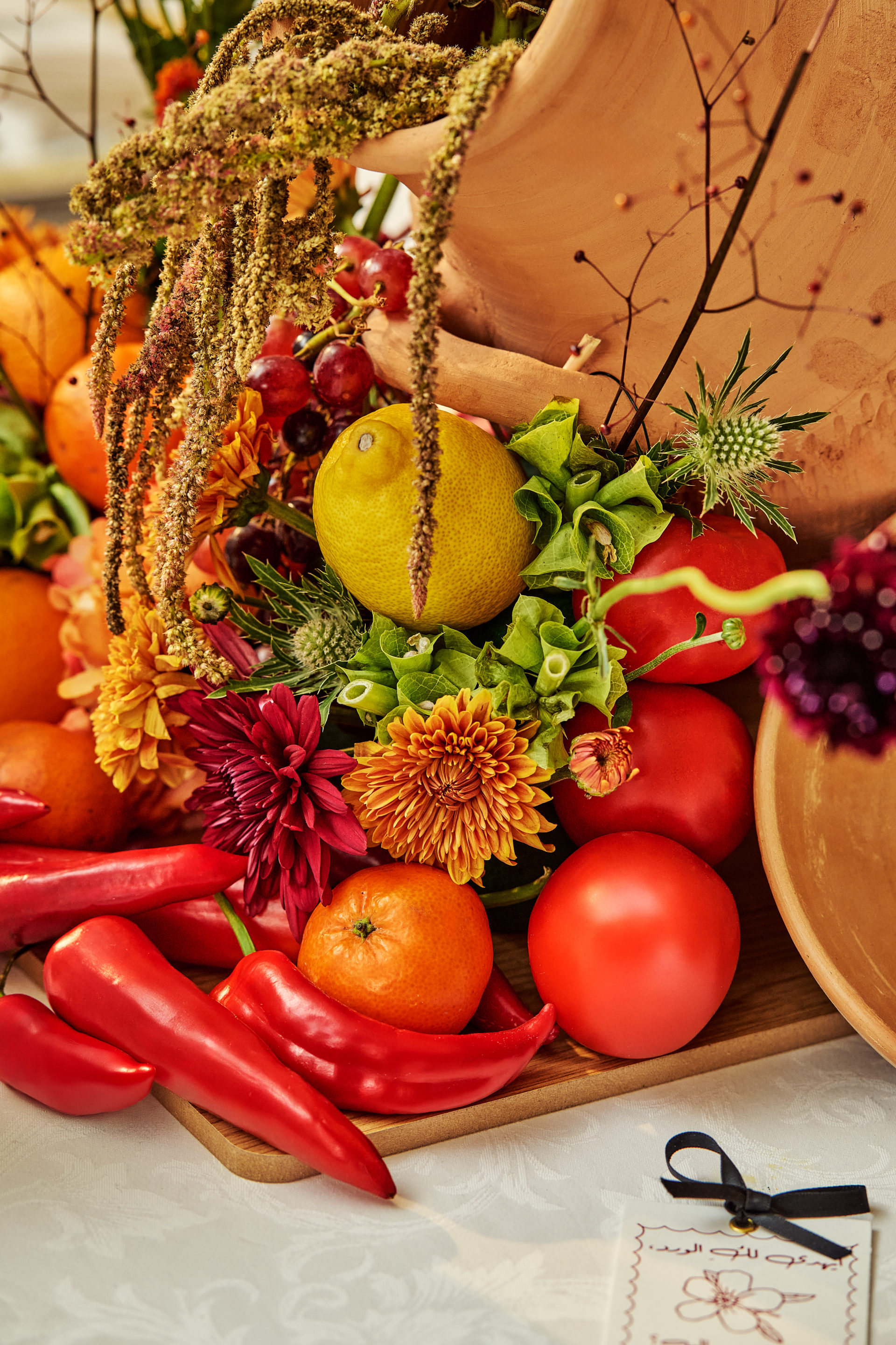 Red drapery, grapes, citrus and floral installations at a Dubai gala event, by Flower Corner — photo 171