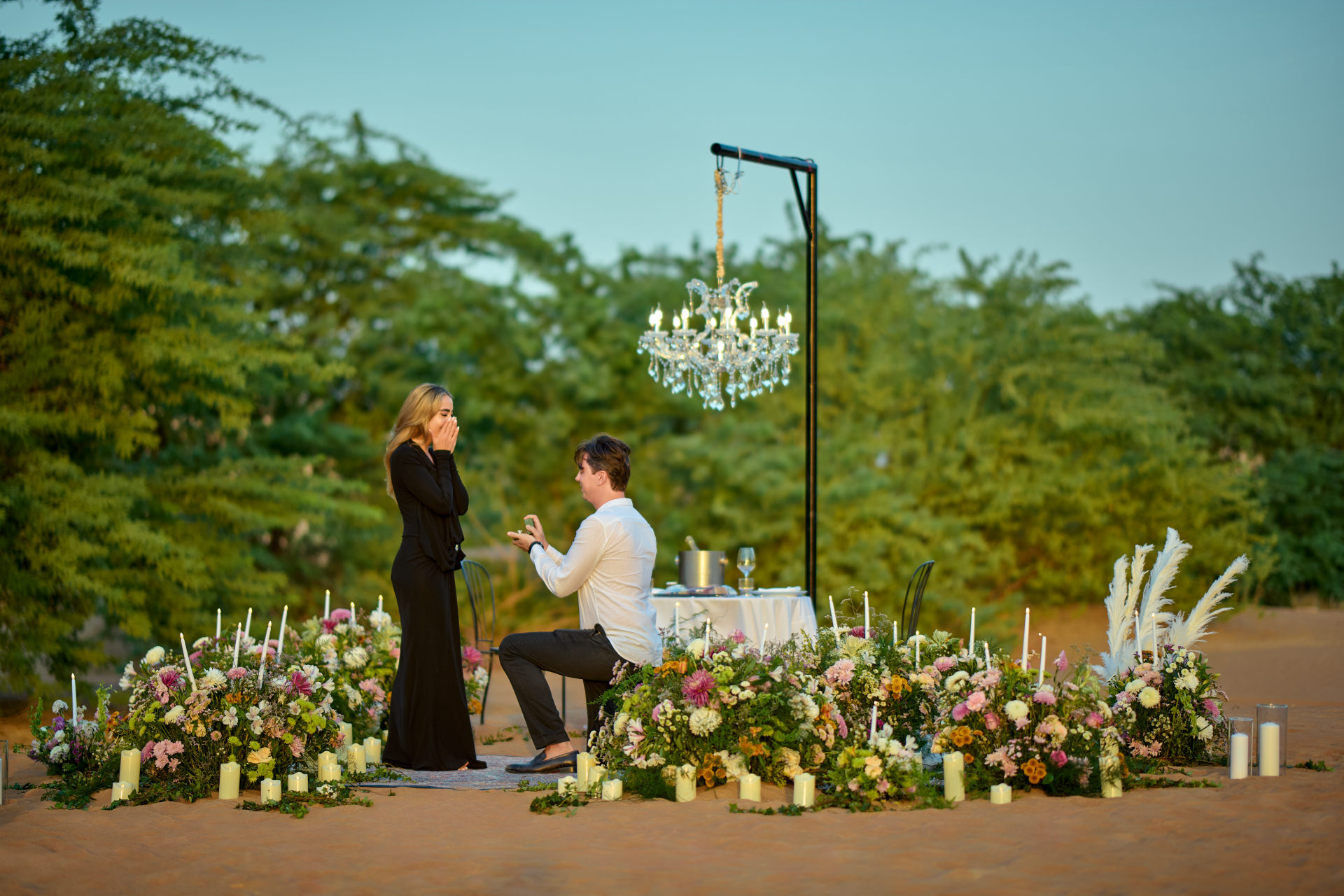 Floral circle, candles and chandelier styling for a desert proposal near Dubai, by Flower Corner — photo 532