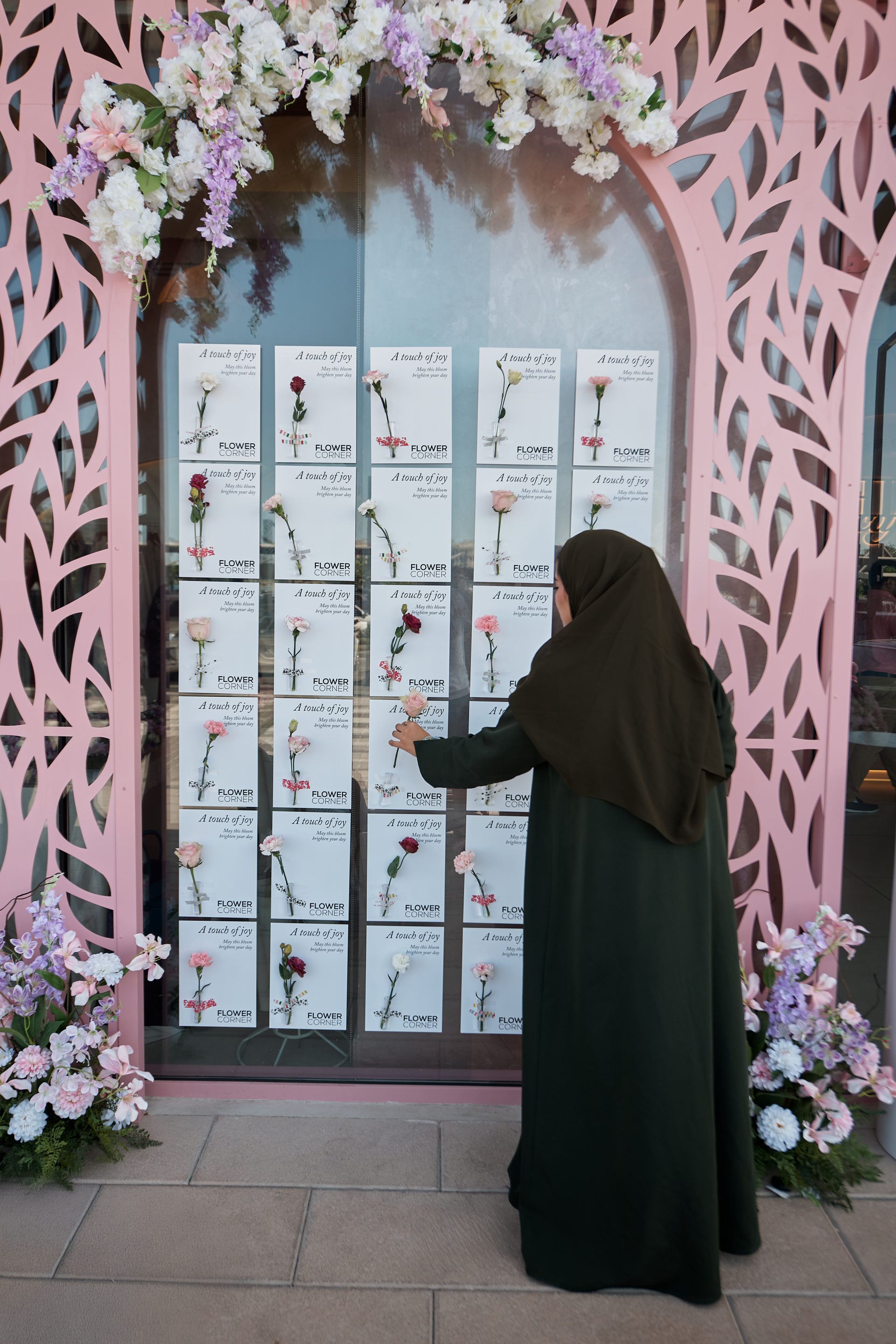 Flower Corner branded flower bar and guest giveaways at a Dubai brand activation — photo 400