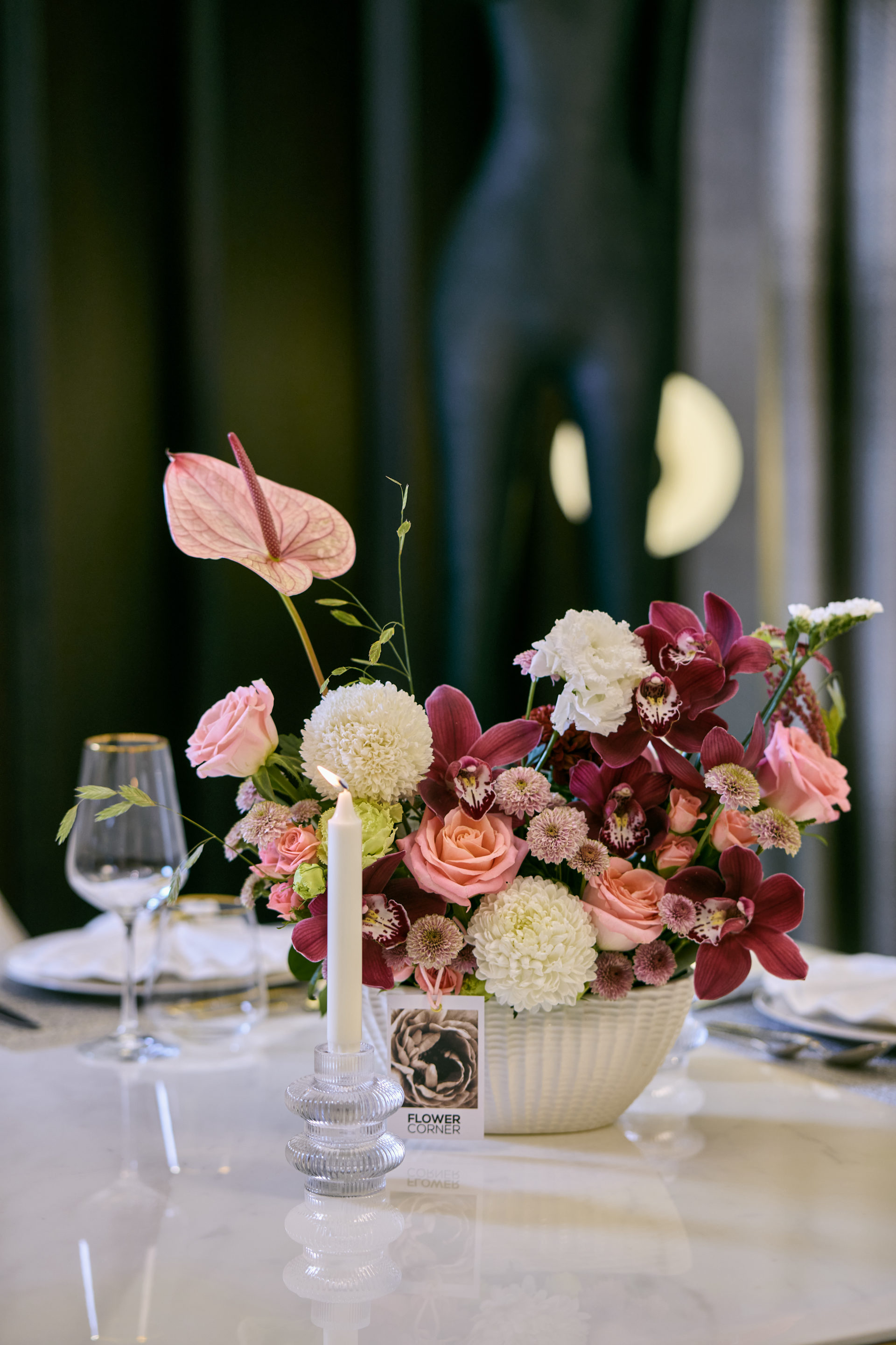 Deep red, pink and white wedding table centerpiece with taper candles at a Dubai reception, by Flower Corner — photo 5