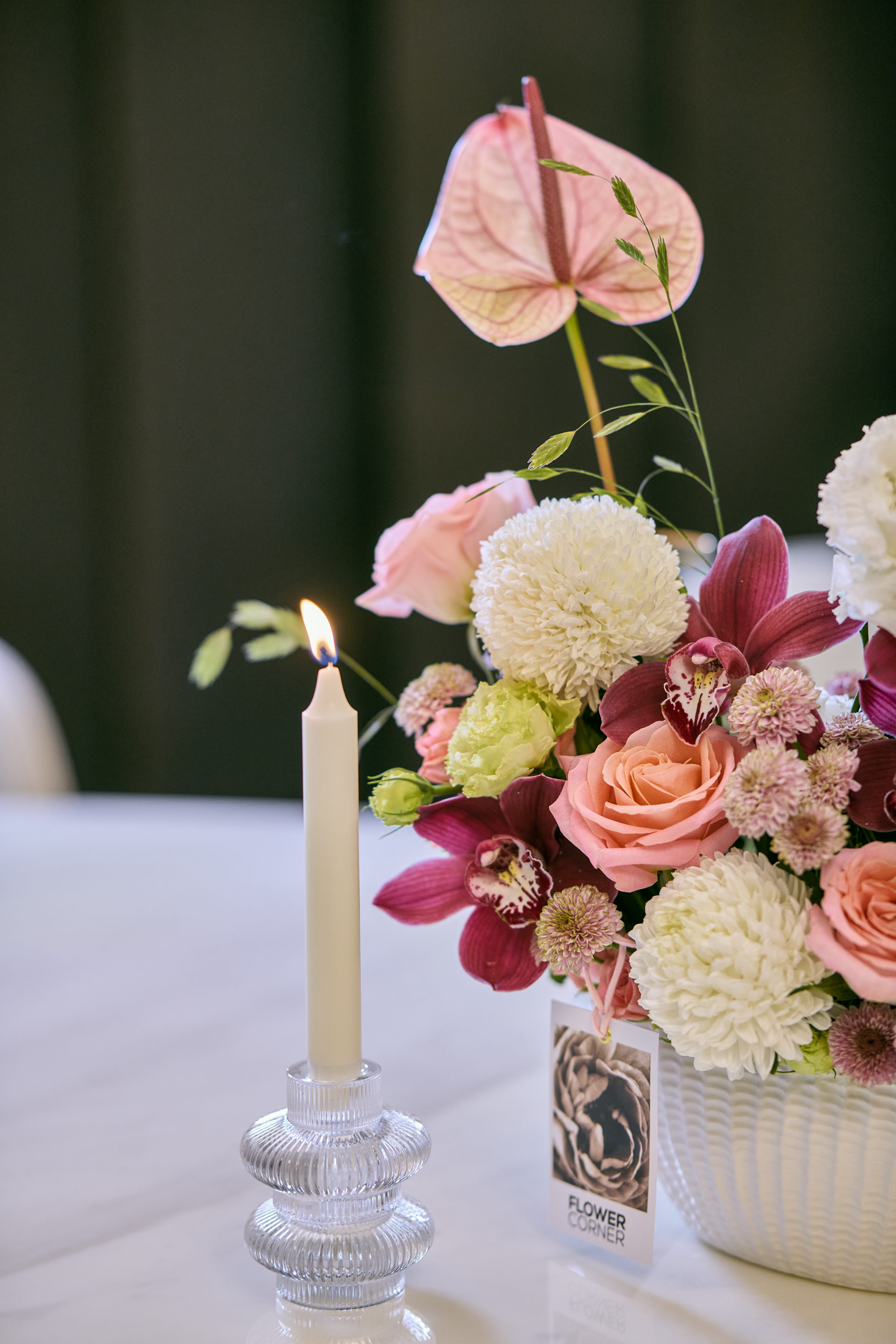 Deep red, pink and white wedding table centerpiece with taper candles at a Dubai reception, by Flower Corner — photo 6
