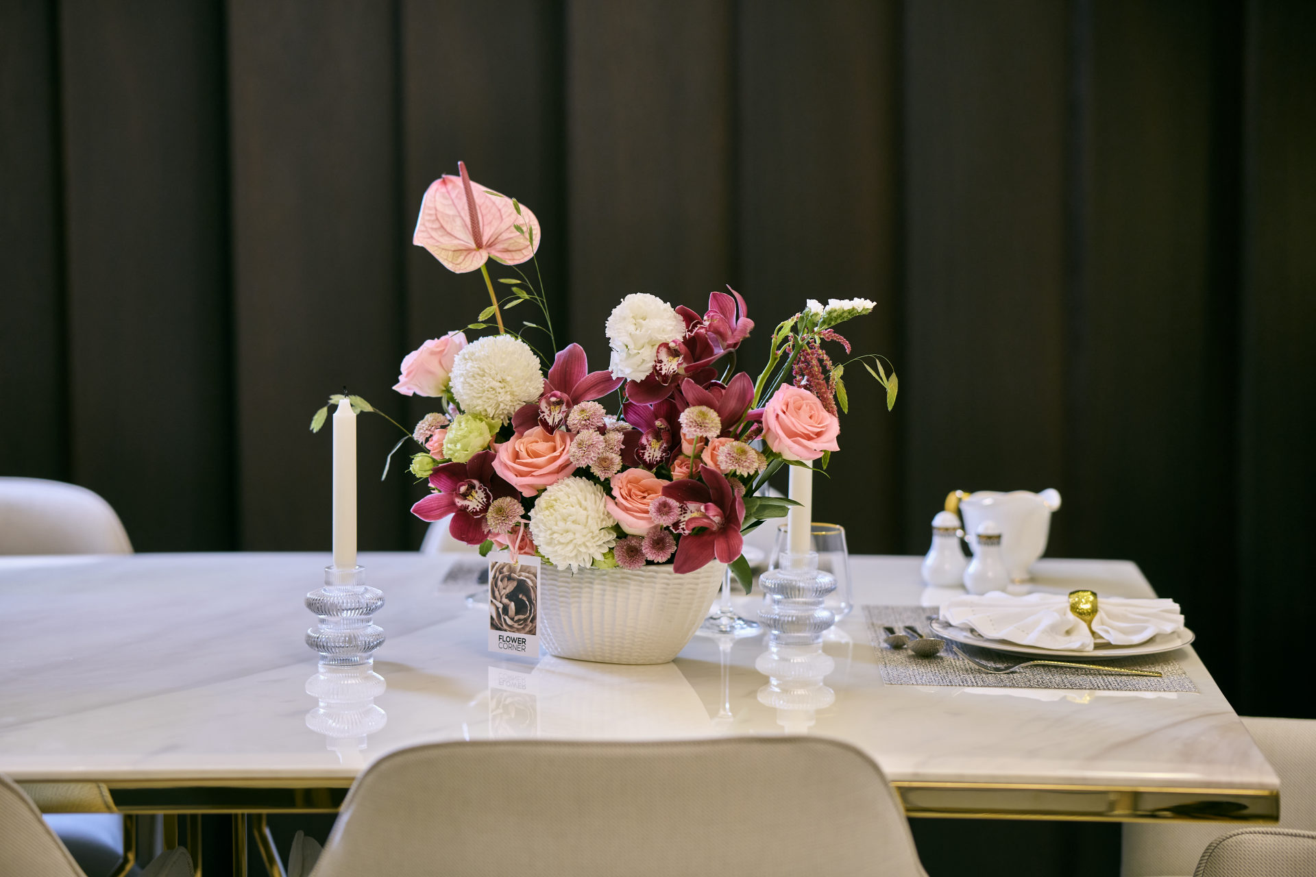 Deep red, pink and white wedding table centerpiece with taper candles at a Dubai reception, by Flower Corner — photo 19